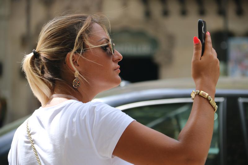 A tourist takes photos in Barcelona's downtown