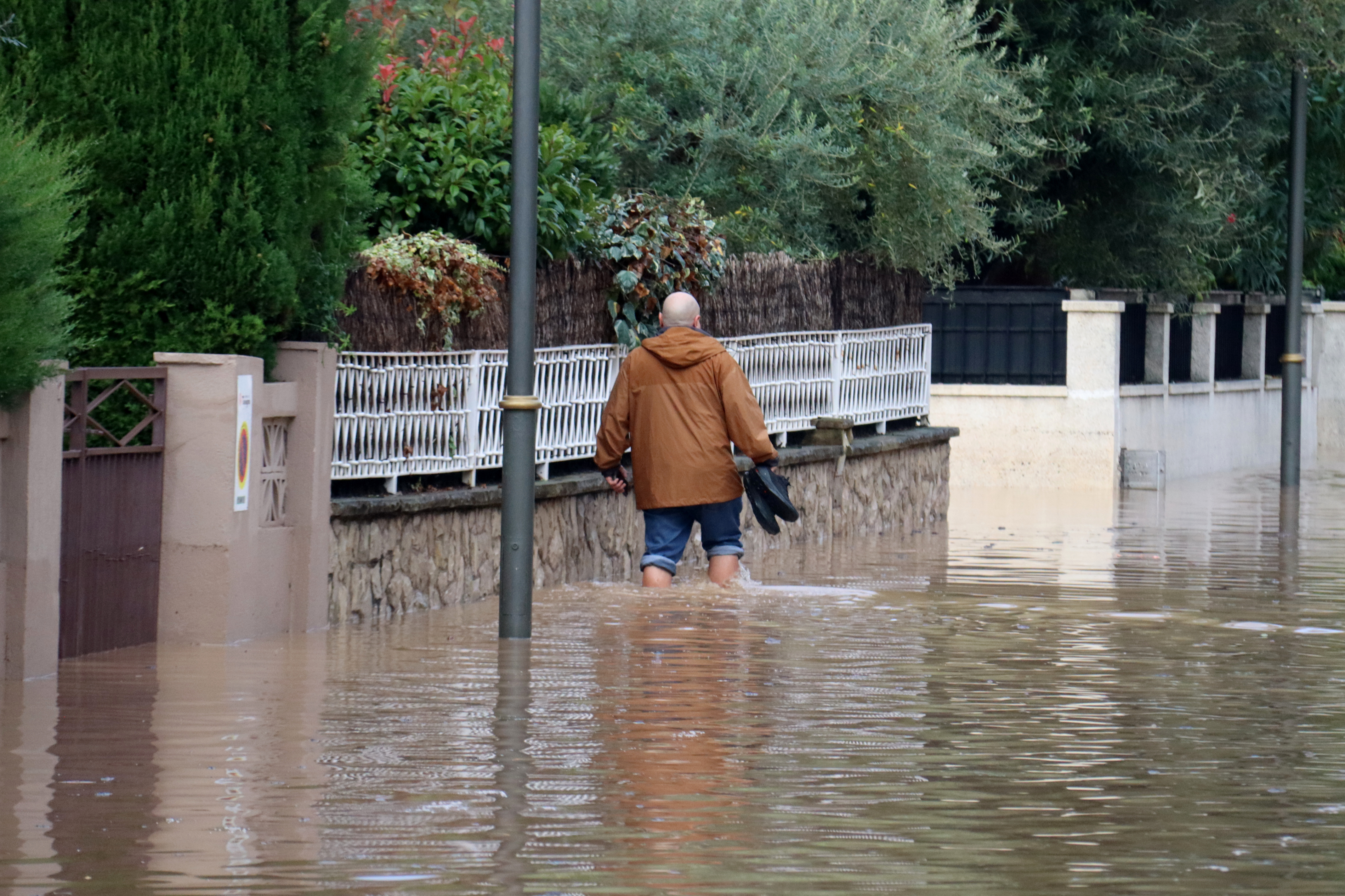 A man walking in a flooded street in Tarragona