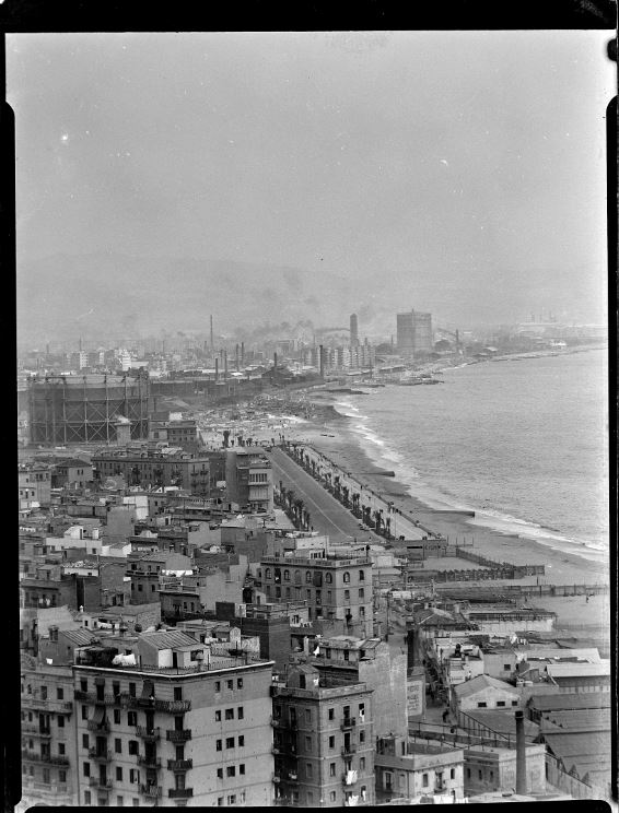 Aerial view of the Barceloneta neighborhood and the Passeig Marítim promenade. In the background, a gas tank and the Somorrostro huts (c.1959)