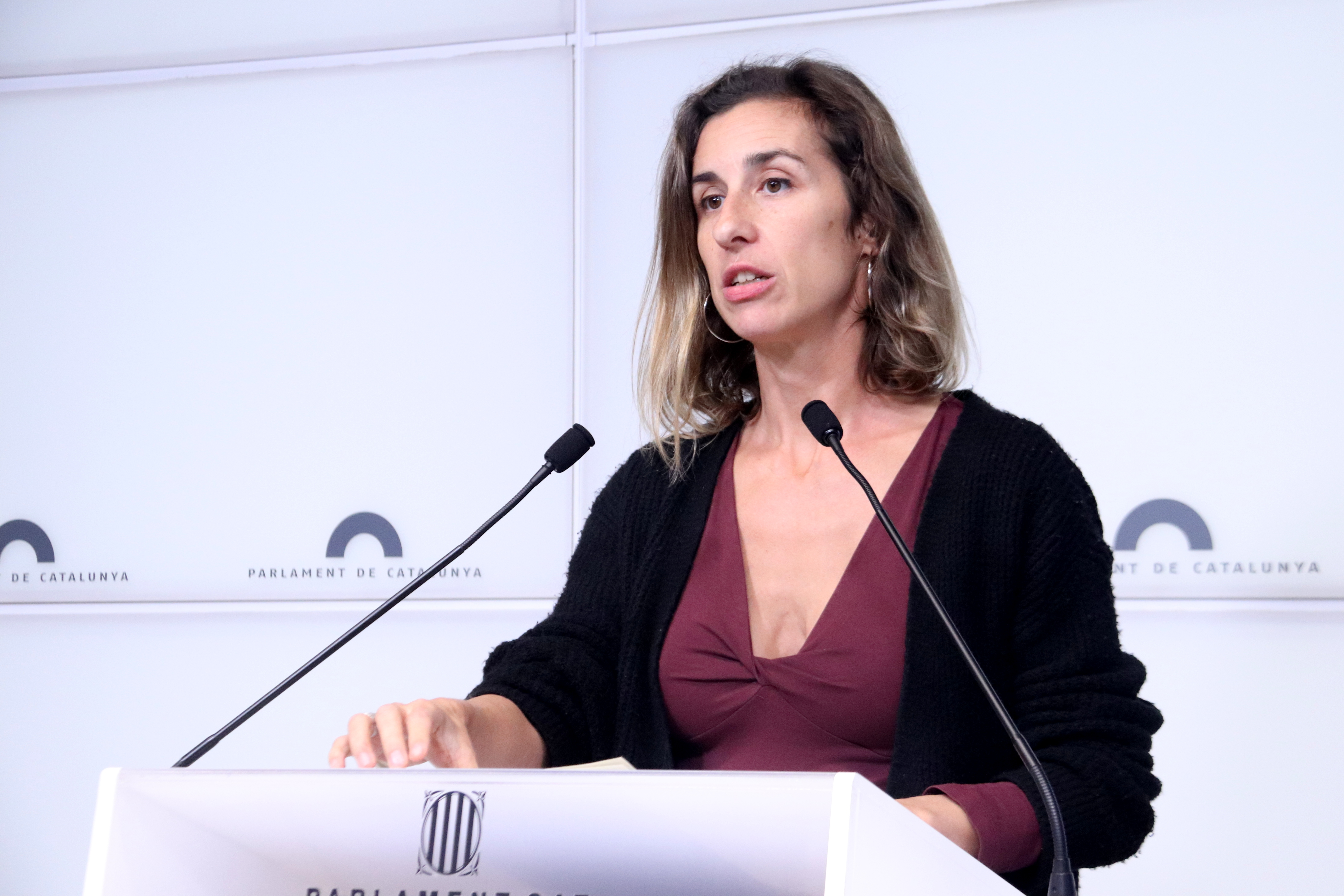 CUP candidate Laia Estrada speaks at a press conference from the Catalan parliament