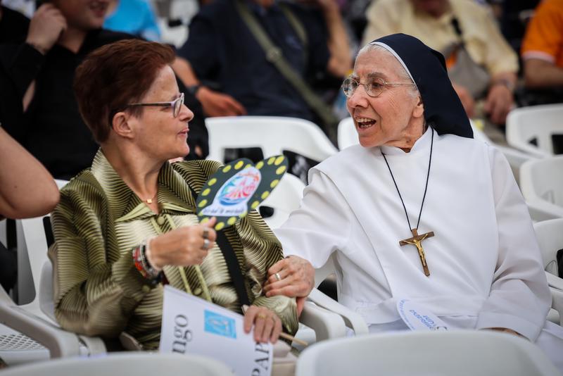 Two people in the Olympic Stadium for the Pope's prayer vigil