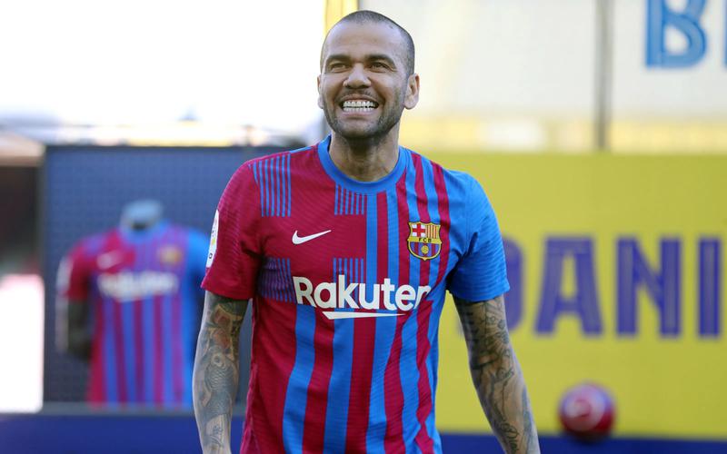 Dani Alves smiles to the fans at the Camp Nou stadium during his FCB presentation on November 17, 2021