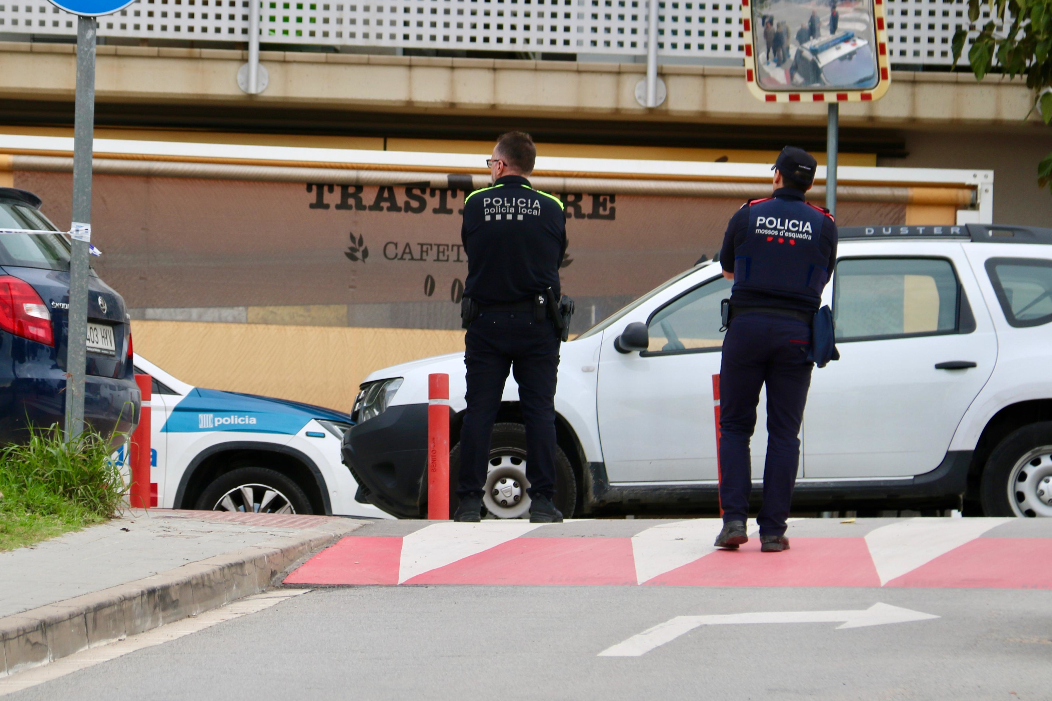 Police in front of the cafe where the shooting took place.