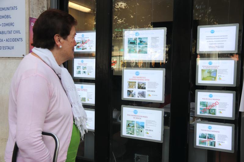 A woman looking at apartments for sale in Barcelona