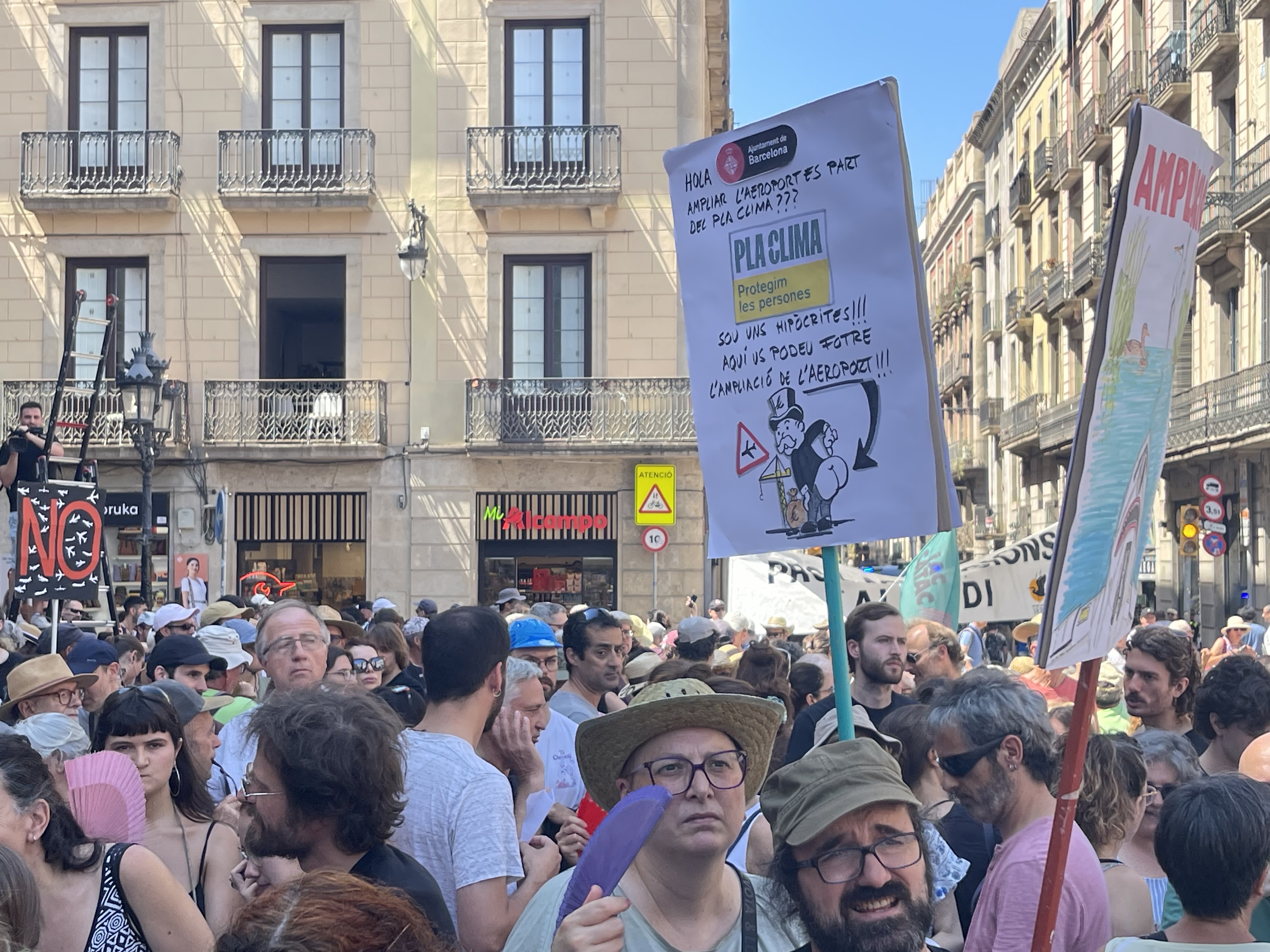 People gather in Plaça Sant Jaume to protest against plans to expand Barcelona airport