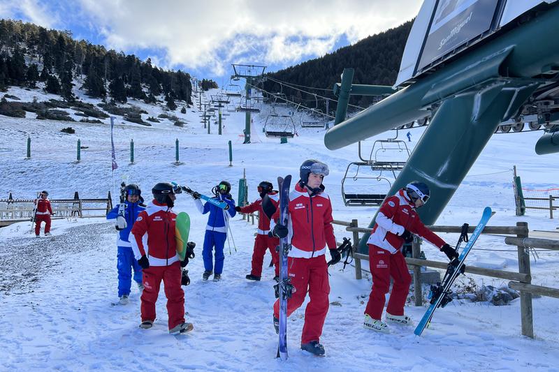 A group of skiers about to board one of the chair lifts in Masella's Coma Oriola sector