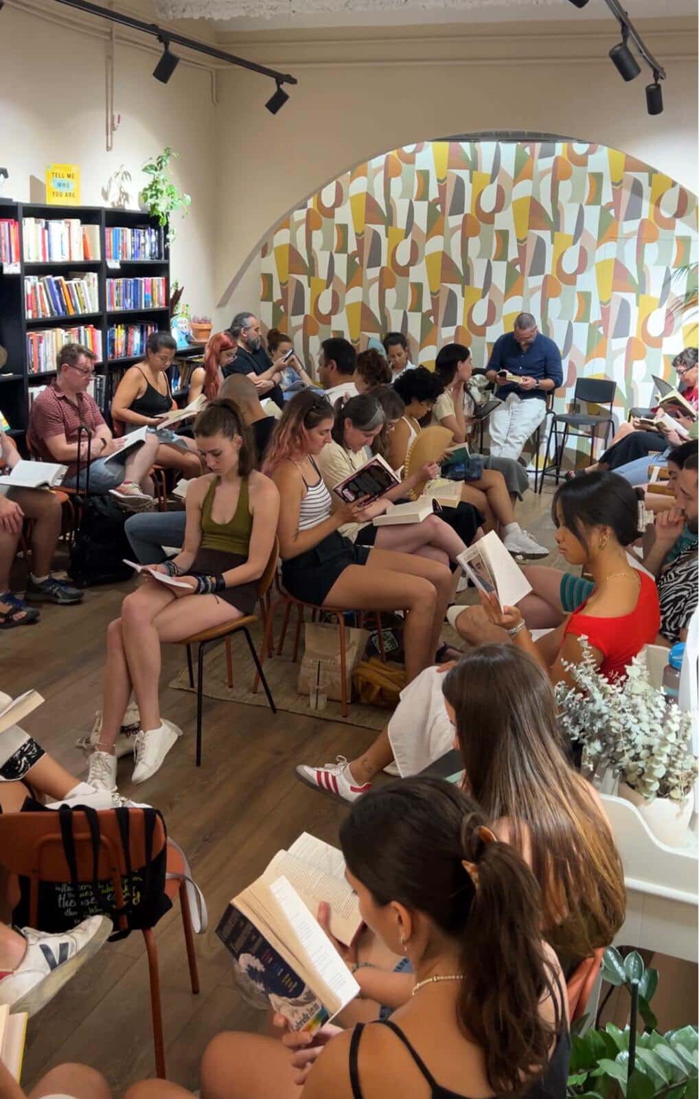 Dozens of people gather in Backstory for a silent reading party