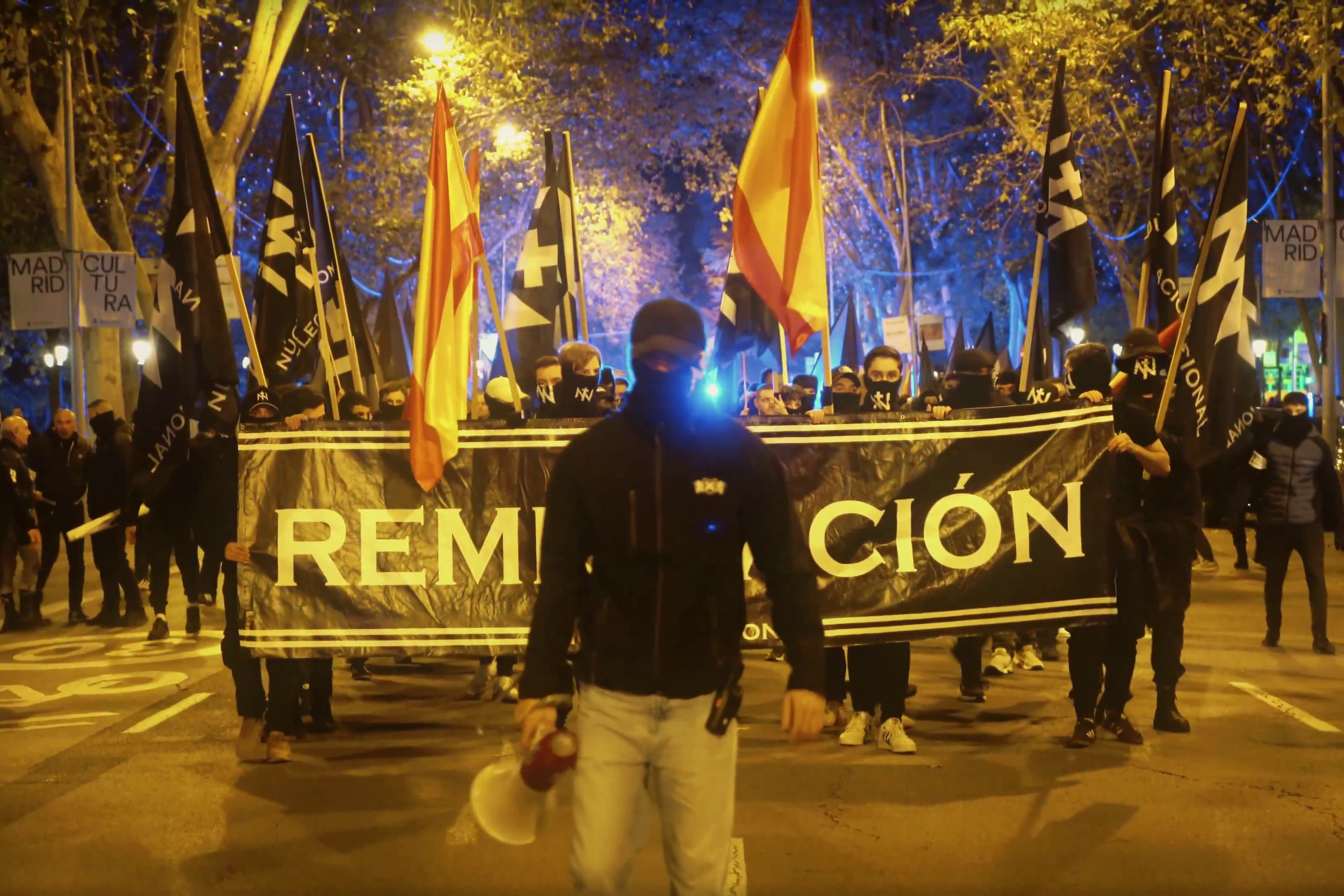 Núcleo Nacional demonstrators display a "Remigration" sign during their gathering