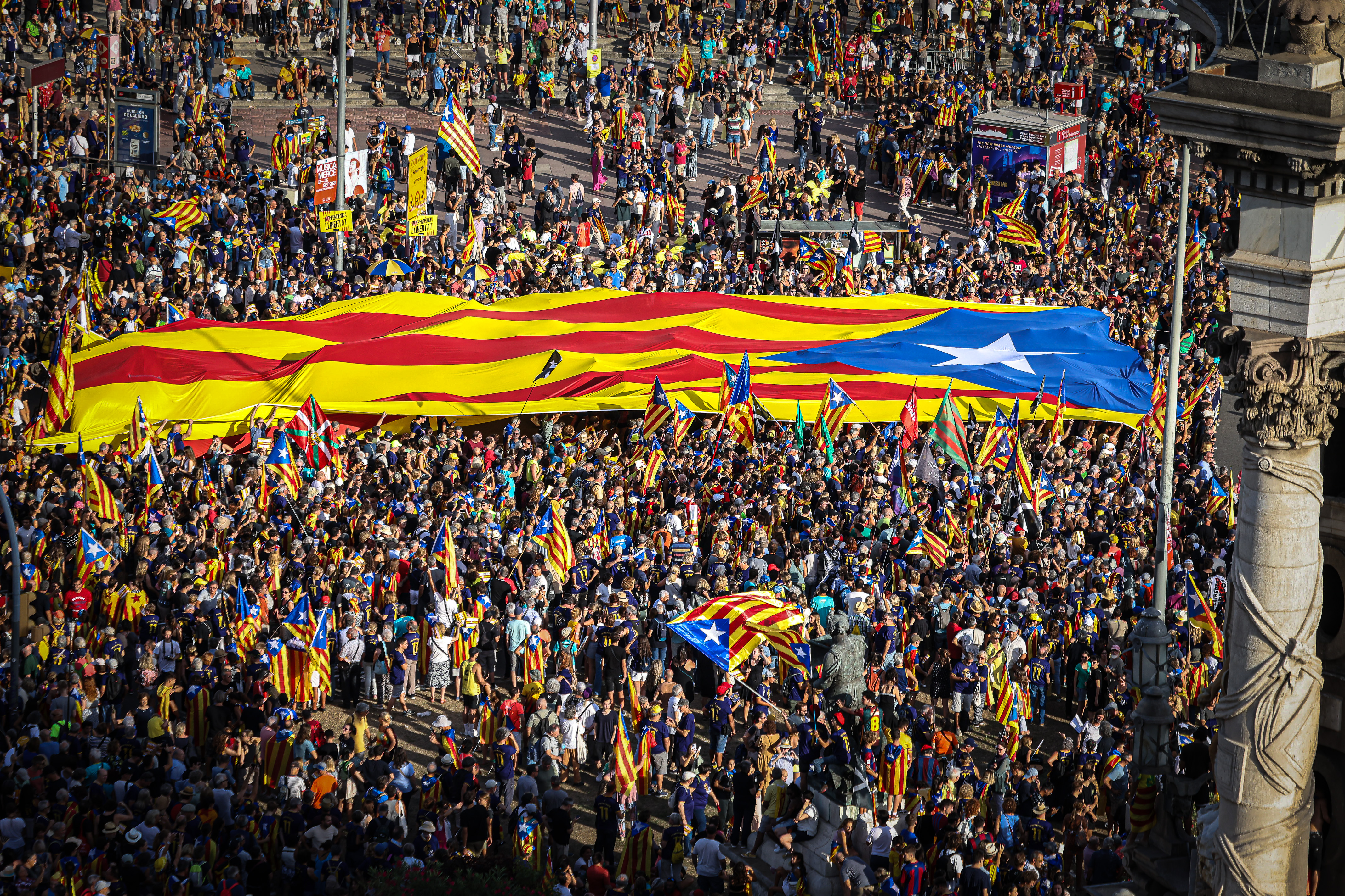 A huge Catalan independence flag is held up by people at the 2023 National Day pro-independence demonstration