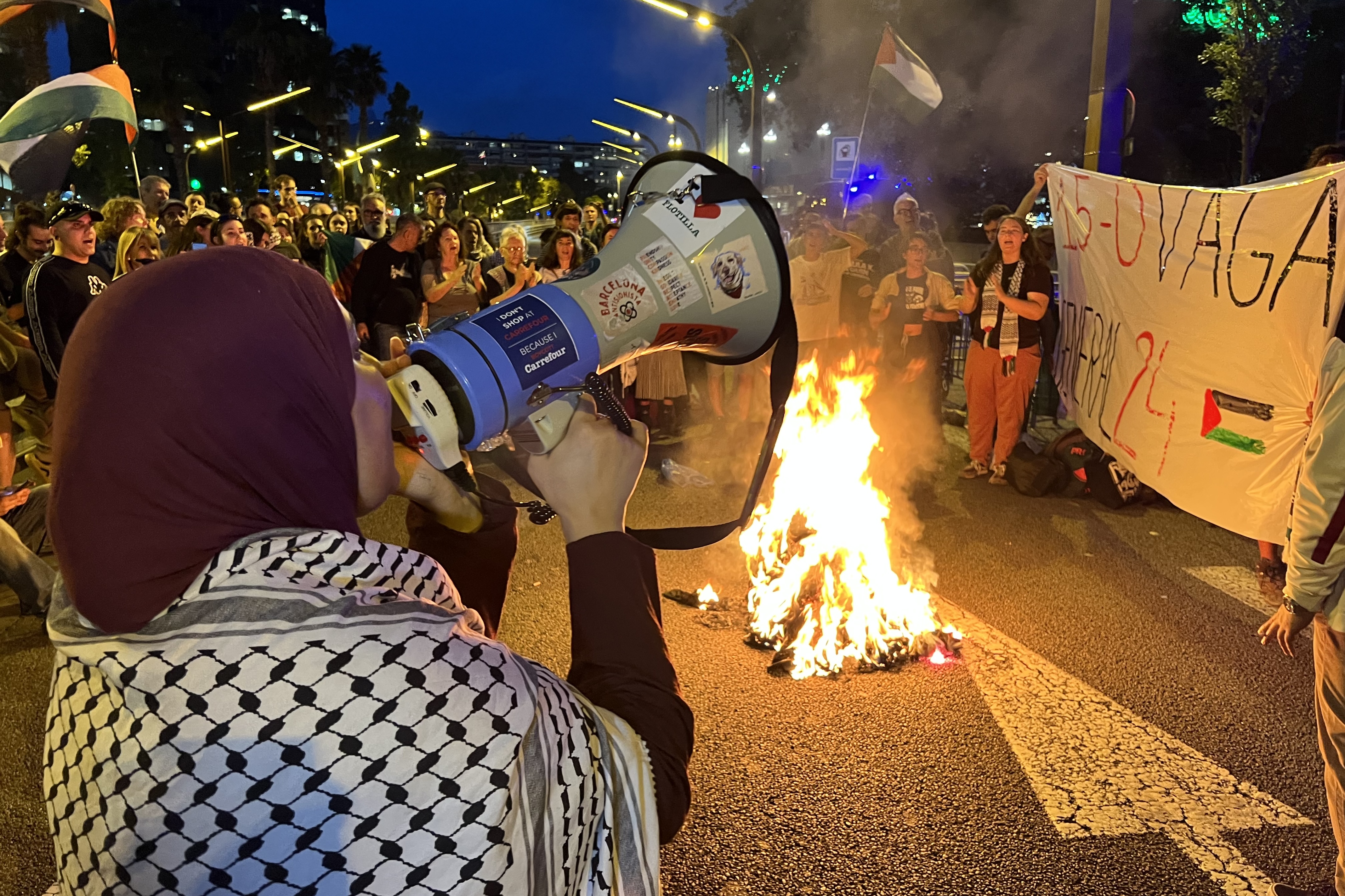 Flotilla activists burn the prison uniforms they wore while being held in Israel