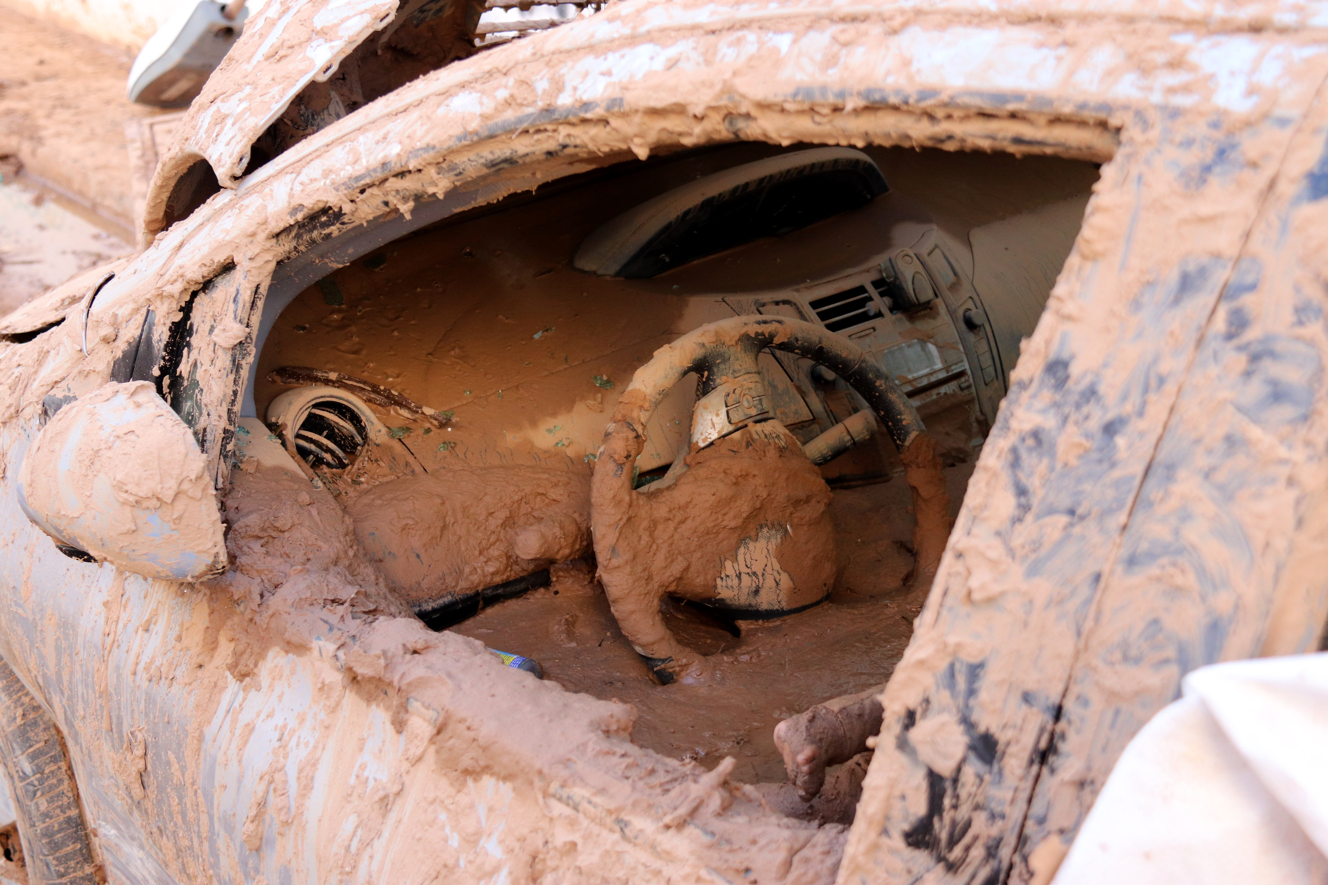 A car in Paiporta flooded with mud