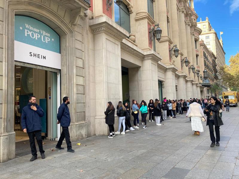 Shoppers queue outside the Shein pop-up store in Barcelona