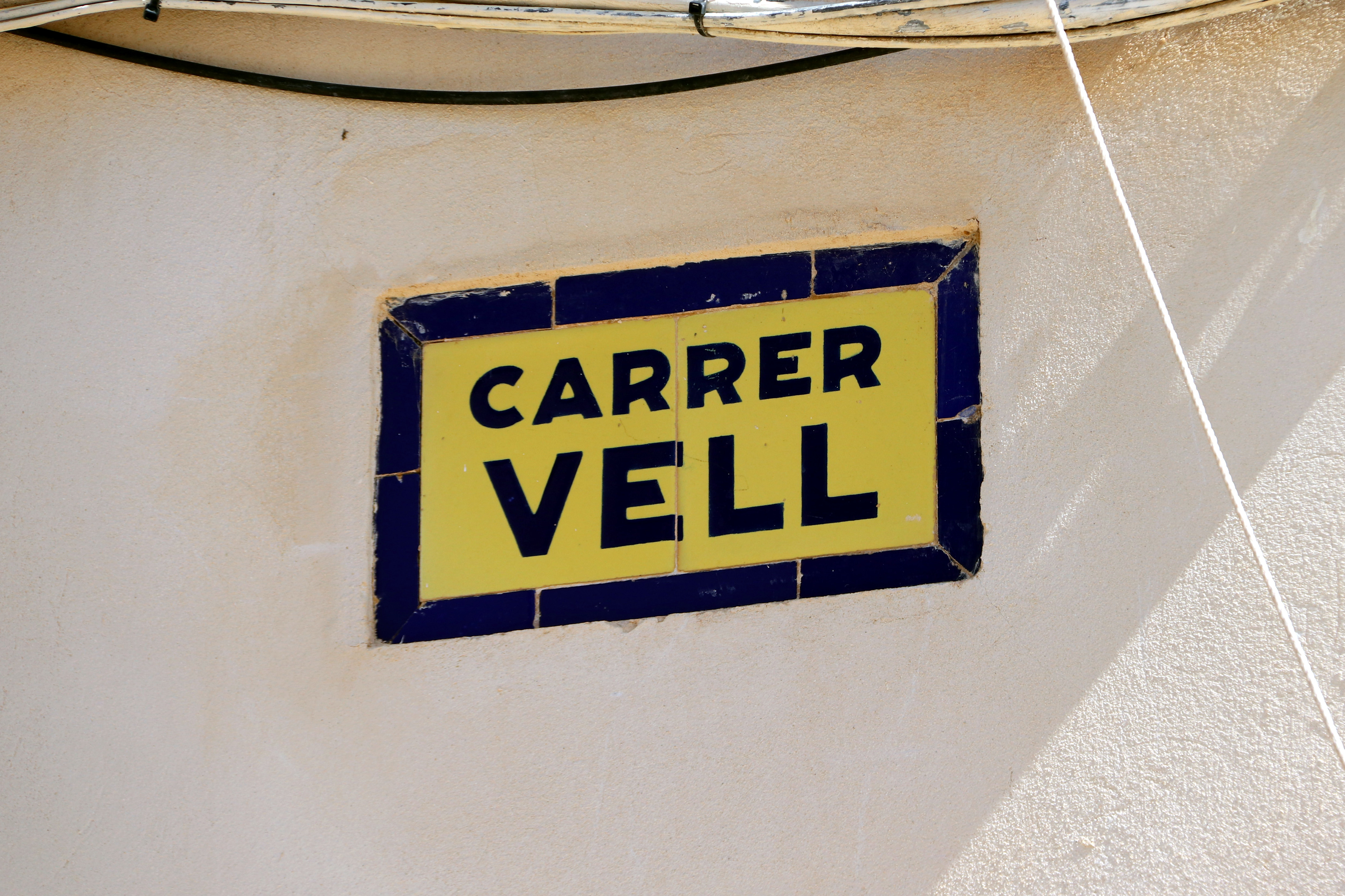 Old Street plaque in L'Ametlla de Merola, central Catalonia, original from before the Spanish Civil War