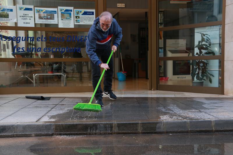 Resident of Alcanar clearing water after heavy rains.