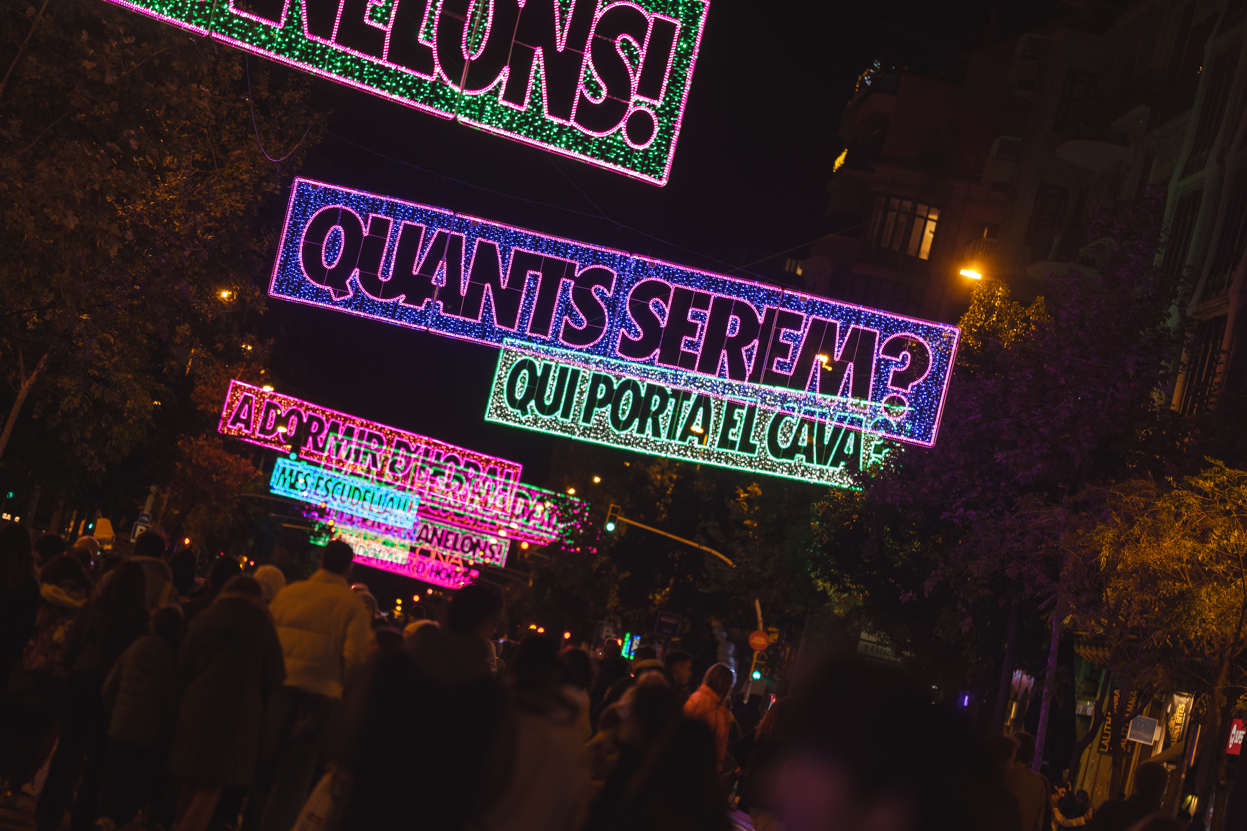 Christmas lights in Barcelona's Aragó street read several Christmas sayings across Catalonia, such as wondering how many people will come for lunch