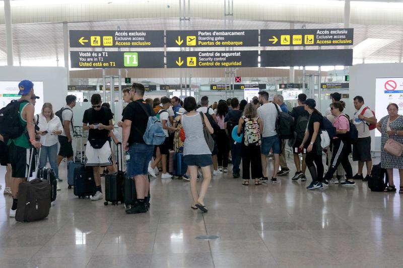 People waiting in line for security at the Barcelona-El Prat Airport