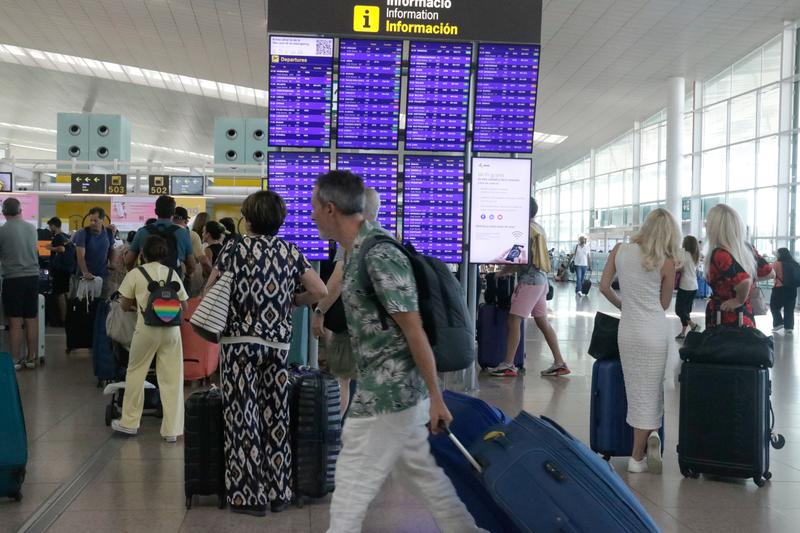 Many Barcelona-El Prat airport passengers carrying suitcases on July 29, 2023 ahead of the summer holidays