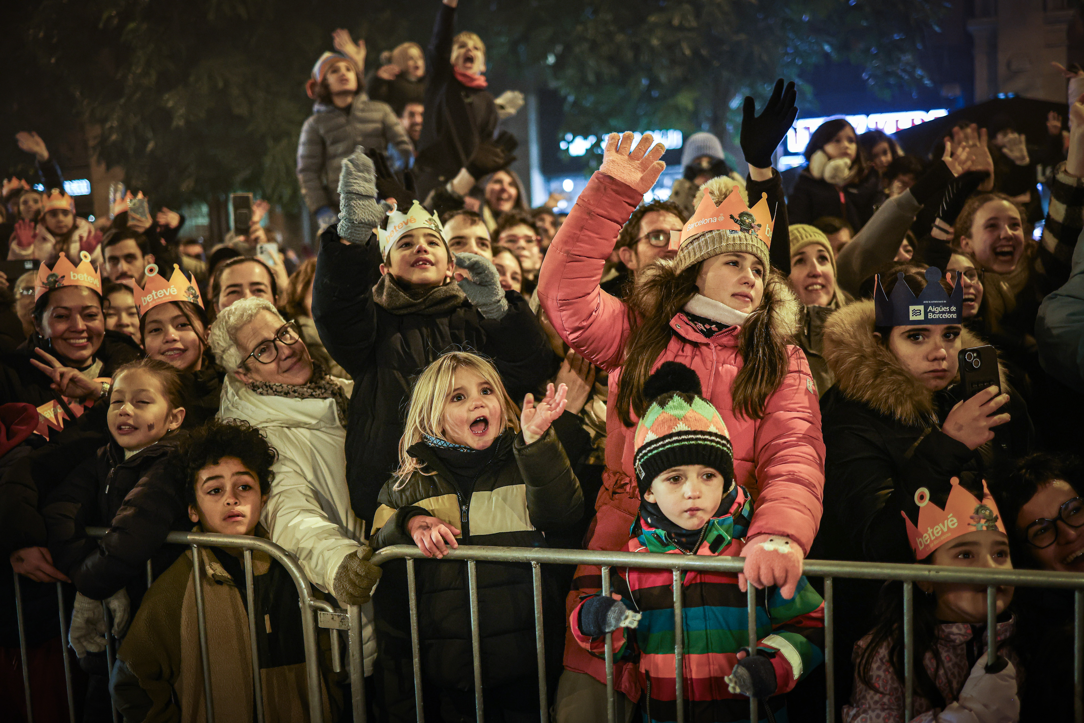 Children wave at the Three Kings Parade in Barcelona