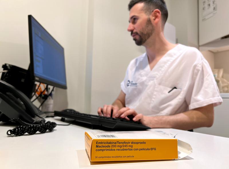 BCN checkpoint worker with box of HIV prevention medicine