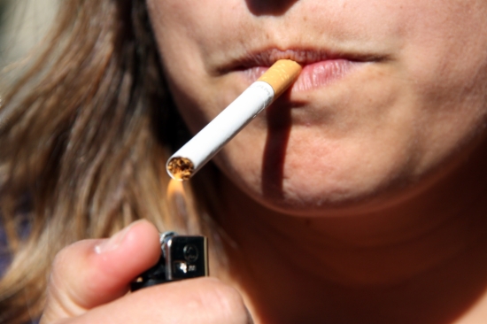 A woman lights up a cigarette
