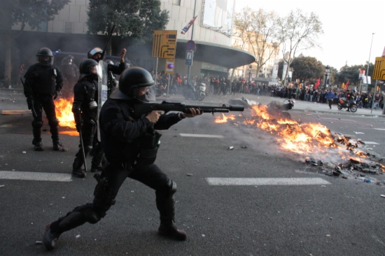Catalan police officer fires rubber bullet in 2013. 