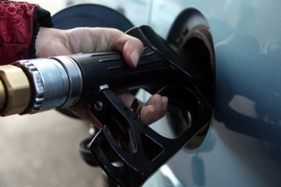 A person fills their vehicle with fuel
